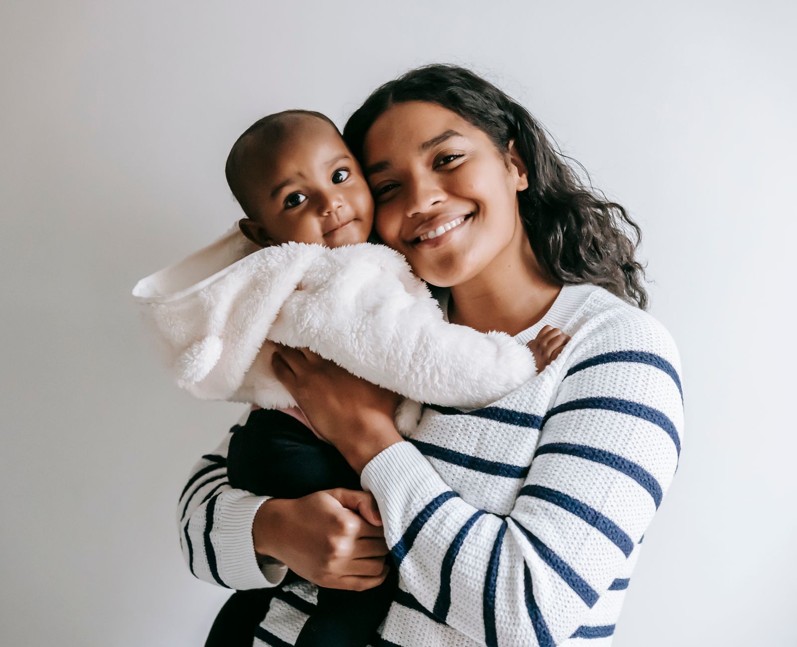 Smiling mother and baby looking at the camera