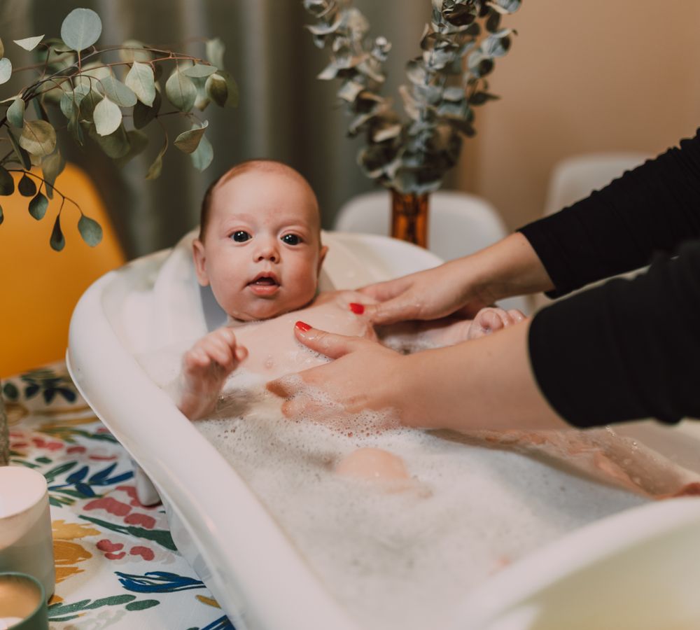 Mother bathing her baby