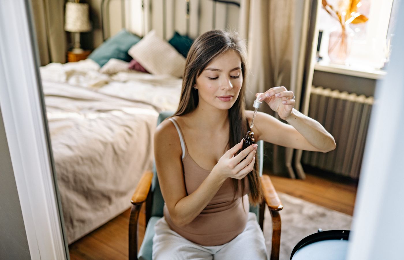 Pregnant woman applying skincare
